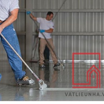 two men rolling epoxy onto floor