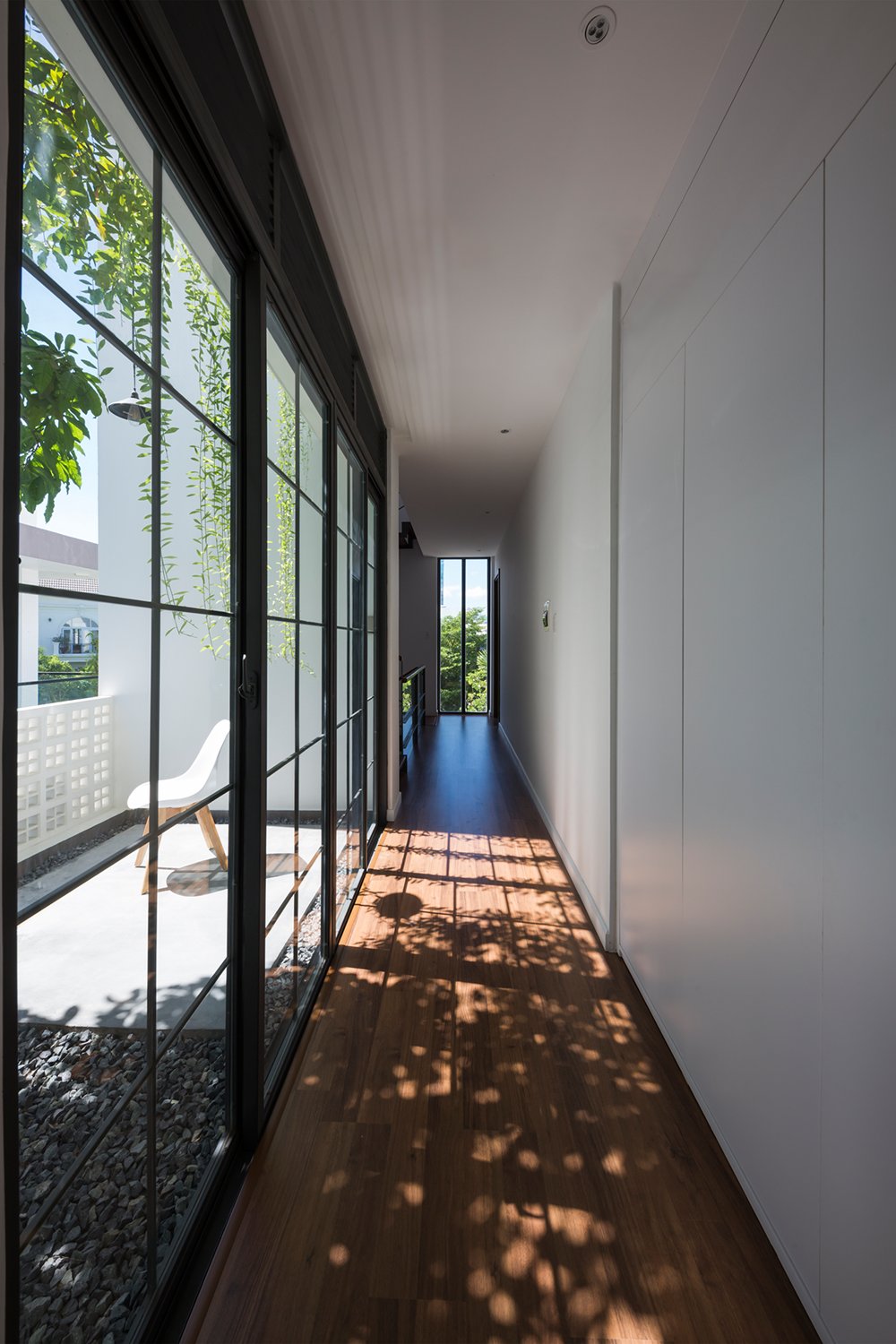 Hành lang dài nối giữa các căn phòng được làm bằng kính giúp mở rộng không gian